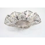 Silver pierced bon bon dish, raised on three bun feet, pierced foliate scroll handkerchief design,