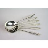 Set of six silver soup spoons, ribbon and bow and garland decoration in relief to terminals,