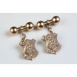 Pair of 9ct rose gold chain link cufflinks, the shield shaped panel with engraved floral and foliate