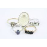 Four gem set 9ct yellow and white gold rings to include tourmaline, chrysoberyl, topaz et and an