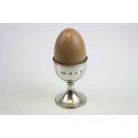 Novelty silver musical egg timer modelled as an egg and egg cup, (the realistic shell should