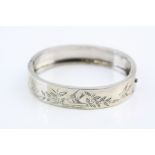 Silver hinged bangle, bright cut swallow and foliate decoration, tongue and box clasp, width