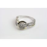 Diamond 9ct yellow and white gold flower head ring, the flower head formed of seven small round