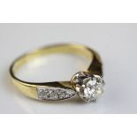 Diamond 18ct yellow gold and white gold set solitaire ring, the principle round brilliant cut