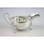 Silver sauce boat raised on three feet, ogee border, makers Viners Ltd, Sheffield 1931