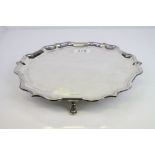 Silver salver raised on three hoof feet, moulded ogee style border, makers Payne & Son, Sheffield