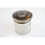 Tortoiseshell and silver topped cut glass dressing table jar, the tortoiseshell lid with silver
