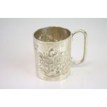 Early 20th century silver mug, repousse floral and foliage decoration to body, C shaped handle,