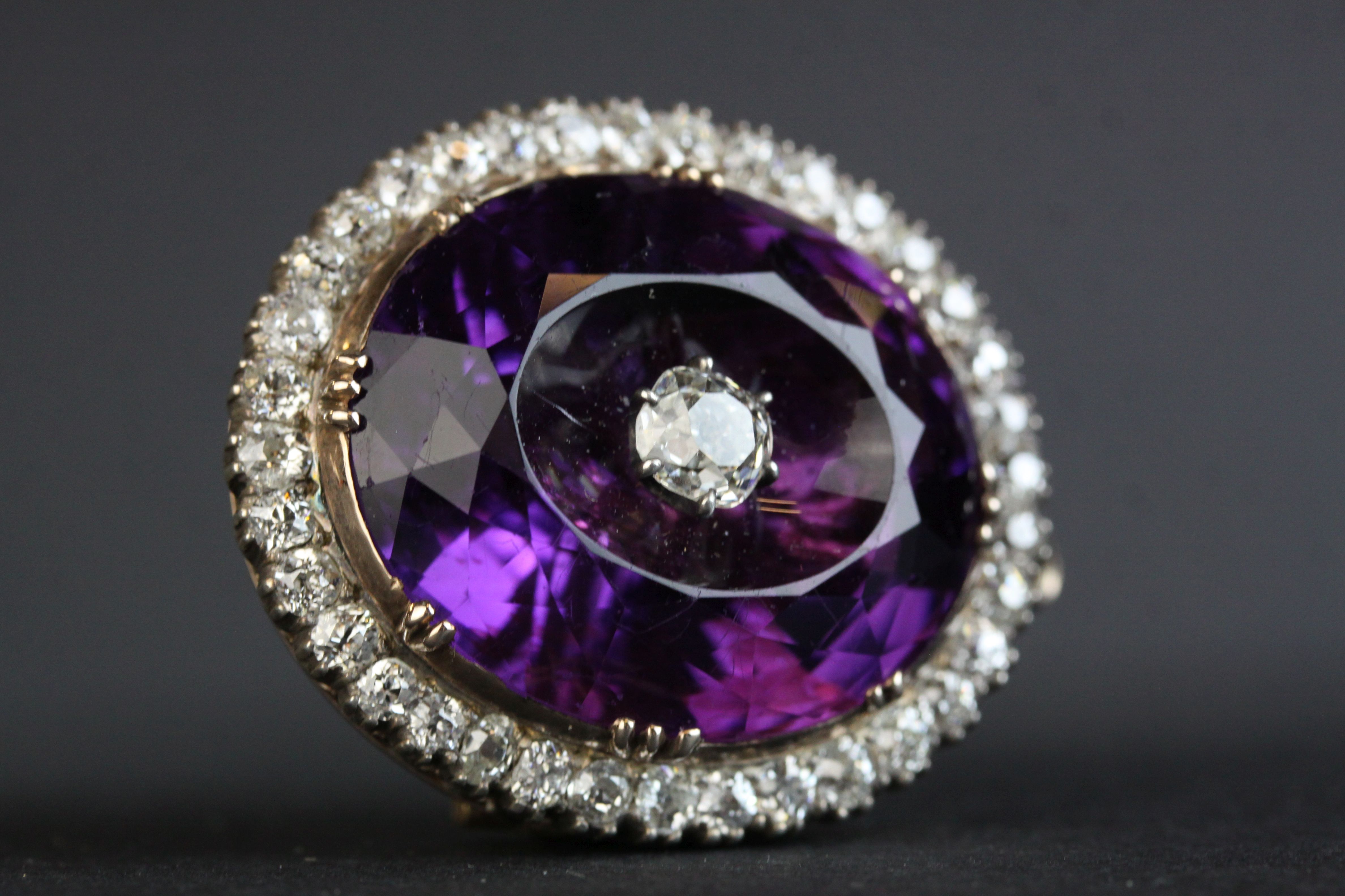 Victorian amethyst and diamond pendant brooch, the large oval faceted amethyst measuring approx 20.