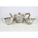 George V Art Deco silver three piece tea service comprising teapot, milk jug and twin handled