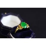 Jade 18ct yellow gold ring, oval cabochon cut jade measuring approx 9mm x 6.5mm, pierced stylised