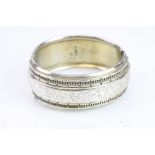 Victorian silver hinged bangle, engraved floral and foliate design to the centre, with repeating