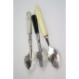 Three Edwardian silver condiment spoons with mother-of pearl; ivorine and serpentine handles, chased