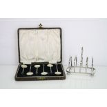 George VI silver five bar toast rack raised on four bun feet, makers Harrods Ltd, London 1937,