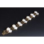 Shell cameo 14ct yellow gold panel bracelet, comprising seven cameos, each depicting a different