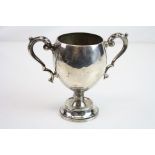 Silver twin handled trophy, plain polished, scroll handles with acanthus leaves, makers Edward