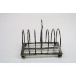 Two similar seven bar silver toast racks raised on four bun feet, makers William Hutton & Sons,