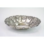Edwardian silver oval trinket dish, repousse floral and scroll decoration to body, pierced sun burst