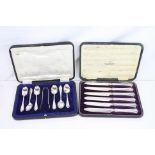 Six early 20th century silver coffee spoons and a pair of silver sugar tongs, decorative terminal,