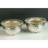 Pair of German silver open salt cellar, hammered design, colourless glass liners, 800 grade