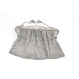 Early 20th century silver chainmail evening bag, the clasp with pierced and bright cut exotic bird