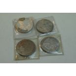 Four United States Of America One Troy Oz .999 silver bullion rounds of various designs.