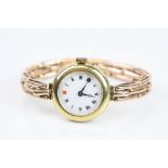 Late Victorian 18ct yellow gold cased wristwatch, white enamel dial, black and red Arabic numerals,