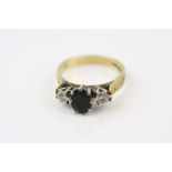 Sapphire and diamond 18ct yellow gold ring, blue black oval sapphire with two small round