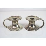 Pair of Edwardian Scottish silver chamber sticks raised on circular moulded bases, makers Hamilton &