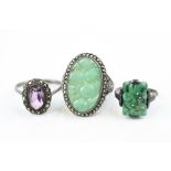 Three silver rings comprising circa 1920s jade ring, a jade and marcasite dress ring, together