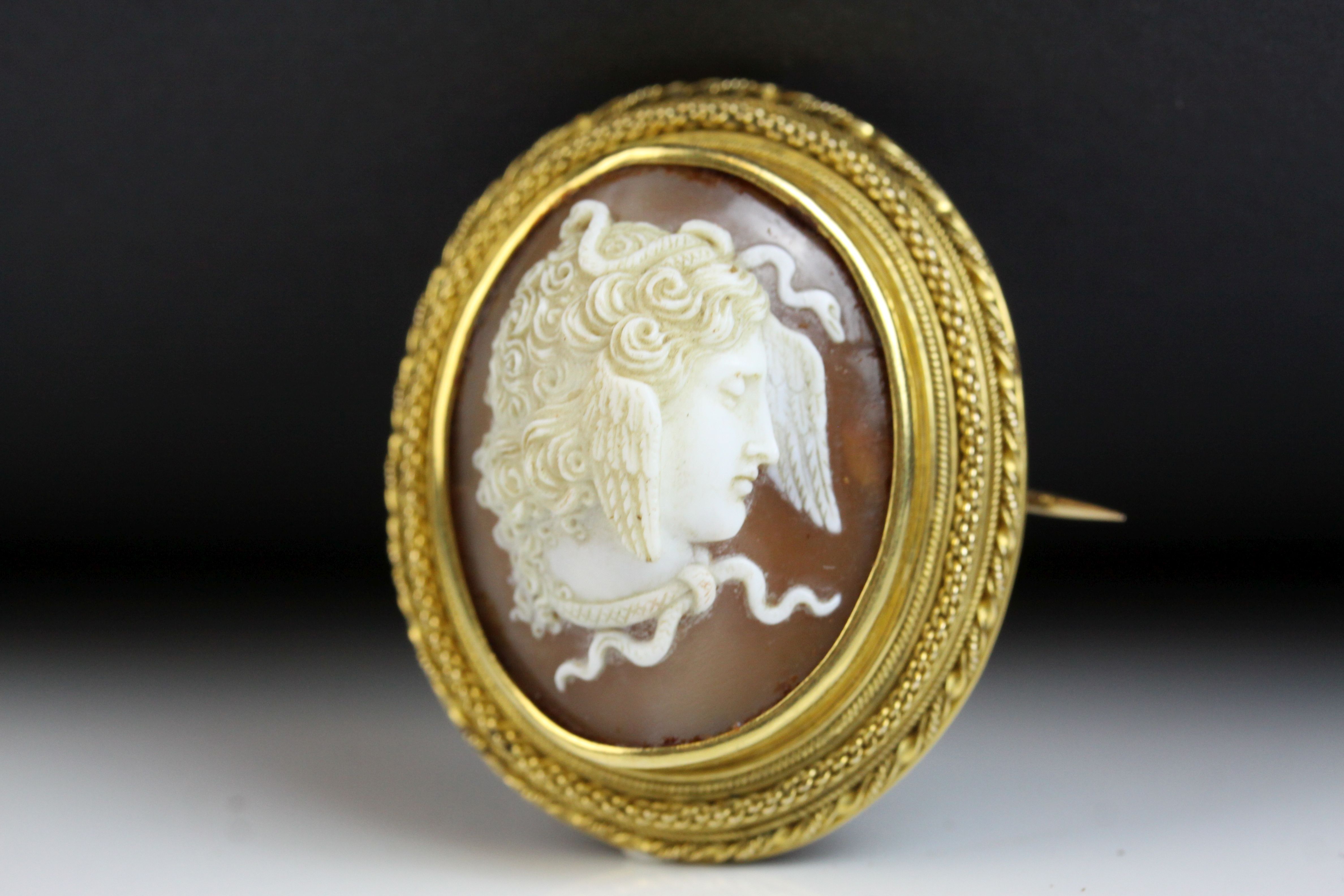 Victorian shell cameo yellow gold brooch depicting Medusa, rub over setting, fancy rope twist and