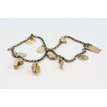 Gold plated bracelet with ten 9ct gold and yellow metal charms