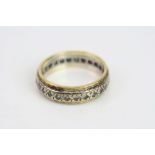 White sapphire yellow metal eternity ring, ring size P½