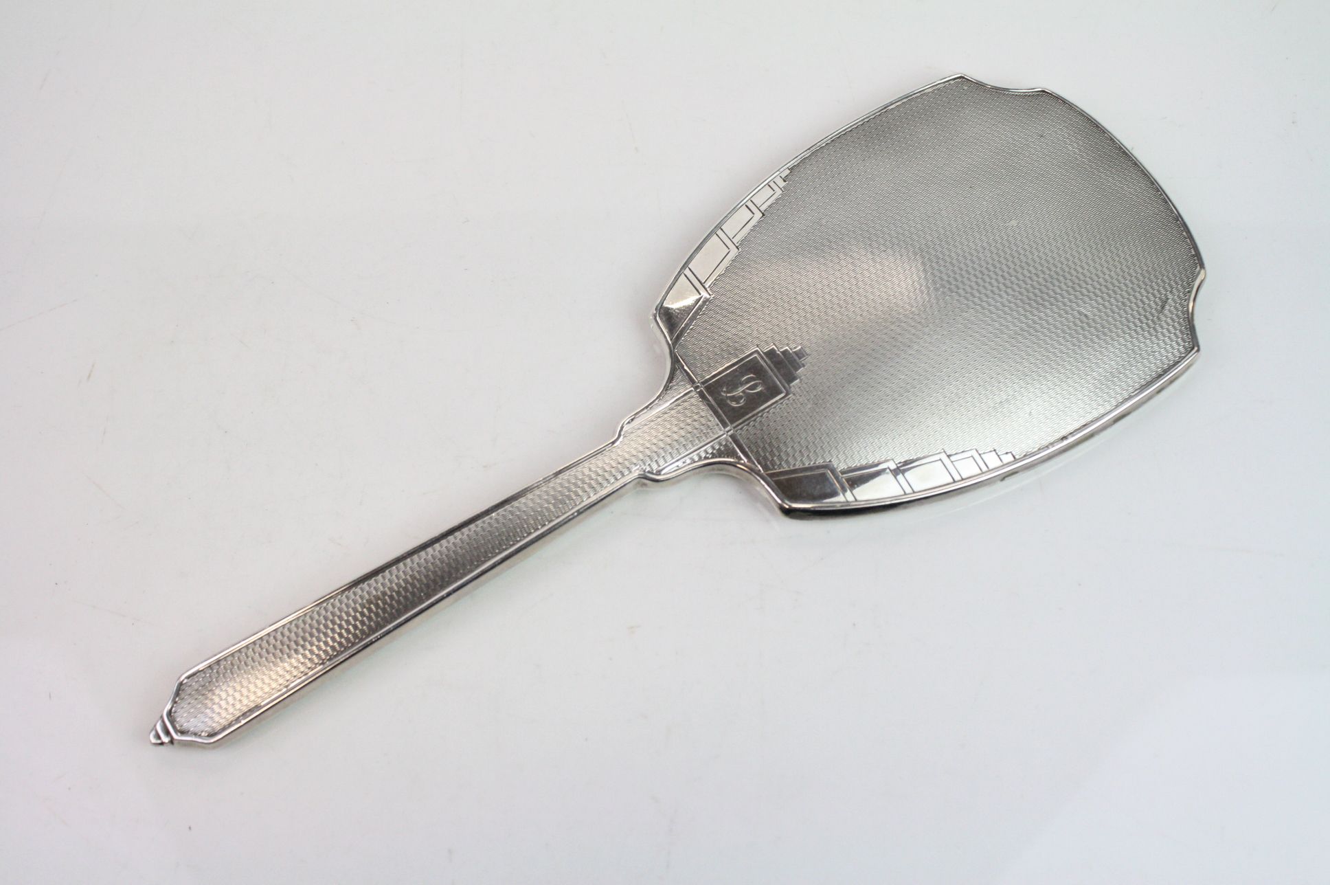 Art Deco silver backed hand mirror, engine turned decoration, stepped details, engraved initial,