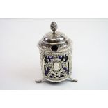 White metal condiment jar raised on three hoof feet, the pierced body with swag and garlands,