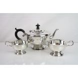 George VI three piece silver tea service comprising teapot, milk just and twin handled sugar bowl,