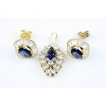 Sapphire and diamond yellow metal pendant, the marquise cut greenish-blue sapphire with small