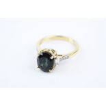 Green stone and diamond 18ct yellow gold ring, possibly a green-blue tourmaline, four claw setting,