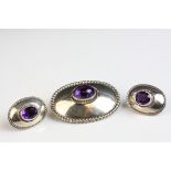 Amethyst silver oval target brooch, central oval cabochon amethyst, rub over setting with rope twist