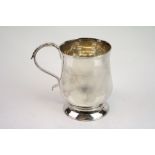 George III silver mug, baluster form raised on moulded foot, scroll handle with cast laurel leaf