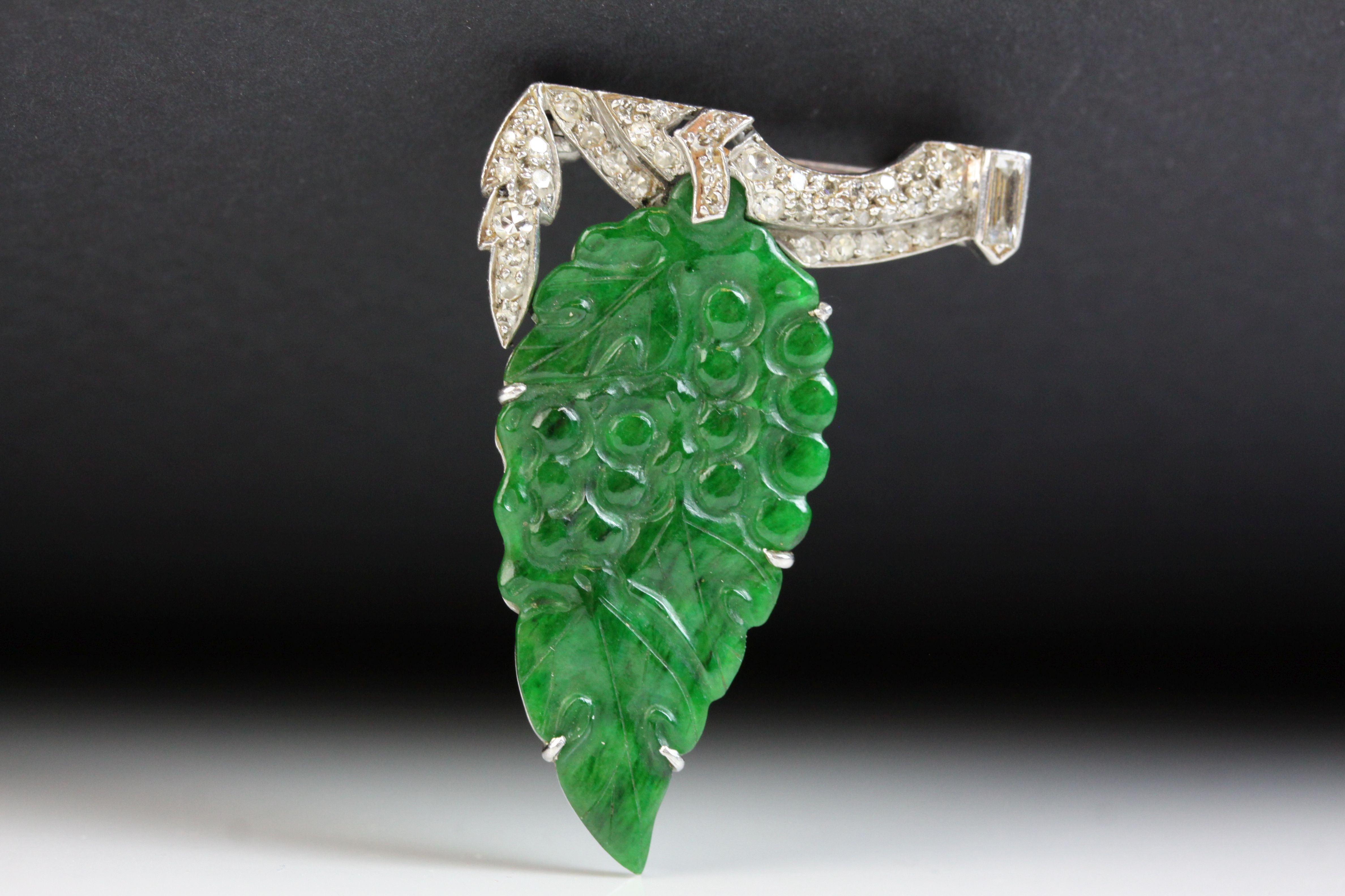 Art Deco jade type and diamond white metal brooch, carved grape and leaf design with small round