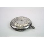 Edwardian silver circular vesta case, engraved floral and foliate scroll decoration, blank shield