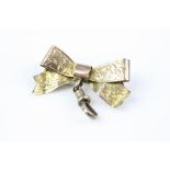 Edwardian 9ct rose gold ribbon and bow brooch with toggle attachment, engraved ivy leaf