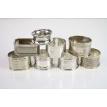 Eight various silver napkin rings to include engine turned decoration, blank cartouche, initialled