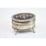 Tortoiseshell and silver oval trinket box raised on four feet, the tortoiseshell hinged lid inlaid