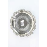 Late Victorian silver salver raised on three feet, engraved foliate scroll decoration, cast