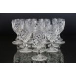 Part suite of moulded and cut glass port and wine glasses, the bowls with spiral decoration (nine