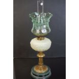 Late 19th / Early 20th century Oil Lamp, the pale green opaque glass well raised on a brass pedestal