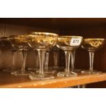 Set of nine cut glass and gilt decorated cocktail glasses
