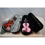 A cased Childs violin with bow together with a similar with pink body.